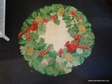 AREA RUG; HOLLY AND CARDINAL THEMED ROUND AREA RUG IN GREEN AND RED. MEASURES 2 FT 6 IN DIA.