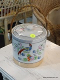 LIDDED JAR WITH WOVEN HANDLE; MADE IN JAPAN AND HAS A HAND PAINTED BIRD OF PARADISE ON THE FRONT
