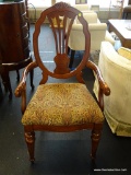 SHIELD BACK ARM CHAIR; HAS A FLORAL PATTERN UPHOLSTERED SEAT AND MAHOGANY BONES WITH A SHELL CARVED