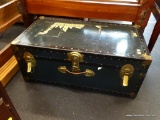 STEAMER TRUNK; GREEN AND BLACK STEAMER TRUNK WITH LEATHER HANDLES AND BRASS HARDWARE. MEASURES 31 IN