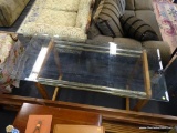 GLASS AND WOOD CONSOLE TABLE; HAS A 1 IN BEVELED GLASS TOP AND PINE BASE WITH BRASS ACCENTS.