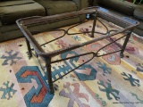RECTANGULAR COFFEE TABLE; TAKES A GLASS INSERT AND HAS PAW STYLE FEET. HAS A BRONZED TONED RIM WITH