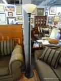 TORCHIERE LAMP; BLACK IN COLOR WITH AN OFF-WHITE SHADE. MEASURES 69 IN TALL