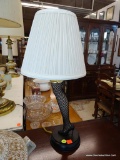 LEGGING LAMP; IN THE FORM OF A LADIES LEG WITH LACED STOCKING AND A HIGH HEEL SHOE. HAS SHADE AND