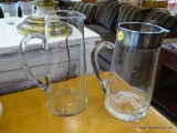 PAIR OF GLASS PITCHERS; PAIR OF GLASS PITCHERS WITH HANDLES. ONE PITCHER HAS A STAINLESS STEEL RIM.