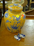 DECORATIVE URN AND MINIATURE CERAMIC CLOGS; BLUE AND YELLOW FLORAL PRINT DECORATIVE CERAMIC URN AND