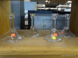 SET OF FOUR GLASS CANDLE HOLDERS; SET OF FOUR GLASS CANDLE HOLDERS WITH HEXAGONAL BASES.