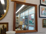 FRAMED WALL MIRROR; LARGE WALL MIRROR FRAMED IN A THICK WOODEN FRAME. MEASURES 35 IN X 41 IN.