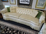 2 CUSHION SOFA; MADE BY WATERS FURNITURE CO. IS CREAM IN COLOR WITH GREEN TRIM AND FLORAL PATTERN