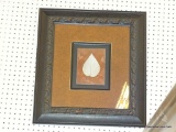 FRAMED LEAF PRINT; CREAM COLORED LEAF ON A BROWN BACKGROUND WITH A BLACK AND BROWN SHADOW BOX MATT.