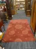 MAROON WOOL AREA RUG; MEDIUM PILE WOOL AREA RUG IN A ORANGE-MAROON COLOR WITH CARVED MEDALLION