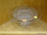 CUT GLASS CAKE STAND; CAKE STAND FEATURES CROSS HATCHING AND STAR CUT DESIGN, WITH A FLUTED EDGE.