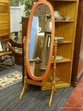 OVAL CHEVAL MIRROR; LIGHT BROWN, OVAL SHAPED CHEVAL MIRROR. FRONT OF FRAME HAS BEEN PAINTED A RED