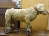 VINTAGE PUSH ALONG DOG WALKER TOY; STRAW STUFFED PUSH ALONG DOG TOY ON CAST IRON FRAME AND WHEELS.