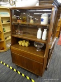 RETRO CUPBOARD; THIS PIECE CONTAINS TWO SLIDING GLASS PANELS ON TOP THAT OPEN TO ACCESS TWO WOODEN