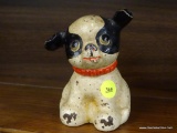 VINTAGE CAST IRON DOG BANK; CAST IRON COIN BANK THAT RESEMBLES A BLACK AND WHITE DOG WITH A RED