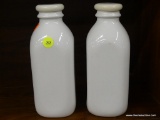 CRATE & BARREL MILK BOTTLES; PAIR OF WHITE PORCELAIN MILK BOTTLES WITH SILICONE LIDS. BOTTLES ARE