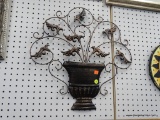 WROUGHT IRON WALL DECORATION; BLACK AND COPPER TONED WALL DECORATION FEATURES A PLANTER WITH SCROLL