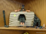 G.I. JOE TOY; THIS IS A GI JOE ACTION FIGURE WITH A CAMOUFLAGE OUTFIT SITTING IN A GI JOE SANDBAG