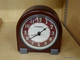 FOSSIL DESK CLOCK; CHERRY COLORED WOOD GRAIN DESK CLOCK WITH CREAM AND TAN STRIPED BACKGROUND.