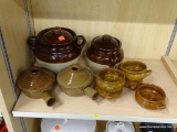 STONEWARE LOT; INCLUDES 2 MONMOUTH POTTERY LIDDED CANISTERS, 2 POTTERY BEAN POTS, AND 5 DOUBLE