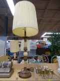 TALL TABLE LAMP; CREAM COLORED PLEATED DRUM SHAPED SHADE ON A CANDLESTICK STYLE BODLE WITH A ROUND