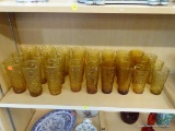 PARTIAL SHELF LOT OF AMBER DRINKING GLASSES; THIS 27 PIECE LOT INCLUDES THREE SIDES OF AMBER COLORED