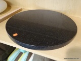 GRANITE TABLE TOP; BLACK GRANITE WITH FLAKES OF LIGHT GRAY. HAS AN 18 IN DIAMETER.