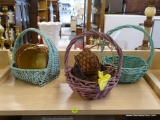 ASSORTED BASKET LOT; INCLUDES 6 TOTAL BASKETS. SOME ARE BROWN, 2 ARE GREEN AND 1 IS PURPLE.