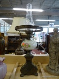 ANTIQUE LAMP; HAS A BRASS BASE AND GLOBE HOLDER WITH A FLORAL PAINTED PORCELAIN BODY AND GLASS
