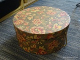 HAT BOX; FLORAL GREEN AND BURGUNDY COLORED HAT BOX WITH ROPE HANDLE. MEASURES 16 IN DIA.