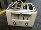 HAMILTON BEACH TOASTER; HOLDS UP TO 4 SLICES AND HAS BEEN HARDLY USED. IS WHITE AND SILVER IN COLOR.