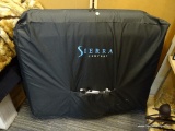 MASSAGE TABLE; IS IN A BLACK CARRYING CASE WITH HEADREST AND INSTRUCTION MANUAL. MADE BY SIERRA