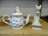 2 PIECE LOT; INCLUDES A WHITE PORCELAIN TEAPOT, AND A EGYPTIAN CAT THEMED TRINKET BOX.