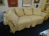 2 CUSHION SOFA; HAS A FLORAL PAISLEY STYLE SLIPCOVER AND 6 MATCHING ACCENT PILLOWS AND IS IN VERY