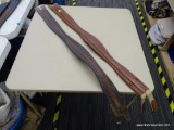 TWO USED 50 IN SHAPED LEATHER GIRTHS; ONE DARK BROWN GIRTH AND ONE CHERRY BROWN GIRTH. MEASURE 50