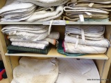 SHELF LOT OF SADDLE PADS; THIS LOT INCLUDES 13 SADDLE PADS FROM VARIOUS BRANDS, INCLUDING: ROMA (4),