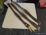 THREE USED 52 IN SHAPED LEATHER GIRTHS; THREE DARK BROWN LEATHER GIRTHS. MEASURE APPROXIMATELY 52 IN