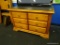TV STAND/ENTERTAINMENT STAND; 2 DOOR MAPLE STAND WITH BLACK PAINTED TOP AND BRACKET FEET. IS IN