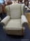 UPHOLSTERED RECLINER; MADE BY NORWALK FURNITURE AND HAS GREEN UPHOLSTERY WITH BRASS STUDDING AROUND