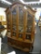 DREXEL CHINA CABINET; HAS FOUR DOORS WITH BEVELED GLASS WITH METAL DOOR KNOBS. ADJUSTABLE GLASS