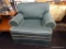 SAGE GREEN ARMCHAIR; GREEN LINEN AND WHITE PIPING ARMCHAIR WITH SKIRT. MEASURES APPROXIMATELY 42 IN