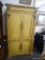 ARMOIRE/ENTERTAINMENT CABINET; 4 DOOR CABINET WITH GREEN AND ORANGE DETAILING AND A FLORAL MOTIF ON