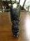 CARVED TRIBAL FIGURINE; BLACK POLISHED STONE. DEPICTS A TRIBAL FIGURINE WITH A LARGE HEADDRESS ON.