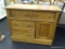 OAK WASH STAND; FEATURES TWO SIDE BY SIDE DRAWERS ABOVE A SINGLE CABINET AND TWO STACKED DRAWERS.