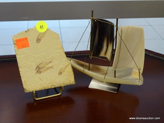 2 PIECE LOT; INCLUDES A FOSSILIZED FISH SLAB AND A SAILING BOAT MADE OF HORN AND SINEW. BOTH ARE IN
