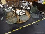 VINTAGE IRON PATIO SET; INCLUDES TWO CHAIRS WITH CURVED ARMS, FOUR LEGS, AND A ROUND IRON TABLE WITH