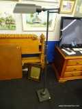 OTT-LITE FLOOR LAMP; BLACK ADJUSTABLE FLOOR LAMP WITH ADJUSTABLE ARM. MEASURES 57 IN TALL.