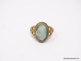 LADIES 10K GOLD RING; GREEN CAMEO CENTER ON A 10K GOLD BAND WITH SCROLLING HEARTS ON THE SIDES. SIZE