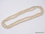 LADIES FAUX PEARL NECKLACE; 36 IN STRAND OF FAUX PEARLS WITH GOLD TONED CLASP.